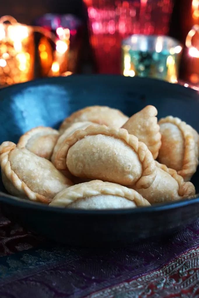 Bowl of handmade ghughra with festive lights